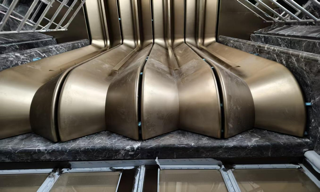 High-End Custom PVD Champagne Gold Stainless Steel Double-Curved Ceiling for Real Estate Showrooms